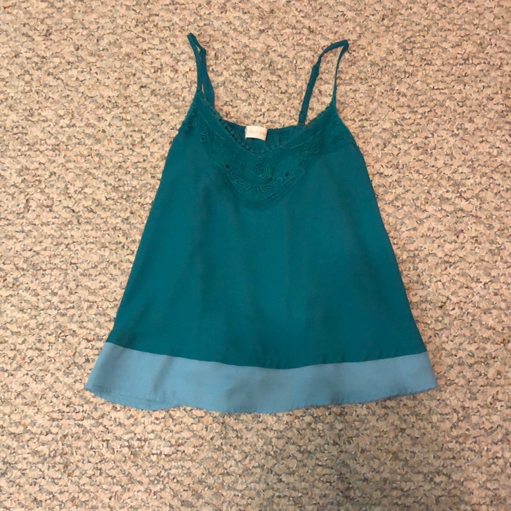 A teal Altar’d State tank top.